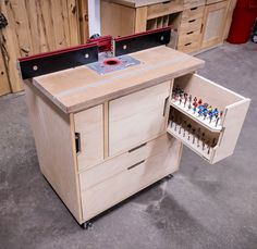 a workbench with drawers and pegs on the bottom shelf for small toy figurines