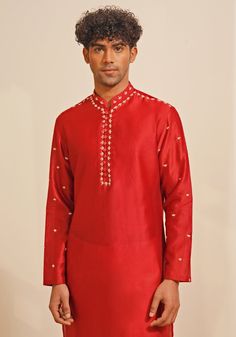 Presenting a regal Red Silk Kurta Set, featuring a Chinese collar and looped fabric buttons for a classic look. The hand-embroidered details on the neckline, shoulder, and sleeves add a touch of elegance. Paired with white pants, this ensemble is perfect for Mehendi or Sangeet events, offering a blend of traditional charm and sophisticated style. Composition : Chanderi Silk Care: Dry Clean Only and Vacuum Storage This product can be customized for sleeves, length and colour Delivery : 4-6 weeks as the product is hand crafted. Check Size Guide or choose MySize for free customisation (All Sizes above XL can be made at 15% additional cost) For more information and sizes please contact fabiliciousfashion@gmail.com or visit our Copenhagen studio. About the Designer : Shreyansh, a distinguished Silk Kurta Set, Chinese Collar, Vacuum Storage, Indian Wedding Wear, Silk Kurta, Fabric Buttons, Embroidered Details, Suit Designs, Kurta Set