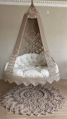 a hammock hanging in the middle of a room with rugs on the floor