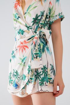 Length: Short. Subcategory: Playsuit. Collar: V-neck neckline. Sleeves: Short Sleeves. Fit: Standard fit. Style: Daily. Fabric: Lightweight woven fabric . Product details: Knot detail. Waist: Elastic waist. runs true to size. S. 100% Polyester Green V-neck Jumpsuits And Rompers For Beach Season, Summer V-neck Jumpsuits And Rompers For Vacation, Casual V-neck Jumpsuits And Rompers With Tropical Print, Tropical Printed V-neck Jumpsuits And Rompers, Summer Tropical Print V-neck Swimwear, White Tie Waist Jumpsuits And Rompers For Vacation, V-neck Swimwear With Tie Waist For Summer, V-neck Tropical Print Swimwear For Summer, V-neck Tropical Print Swimwear For Vacation