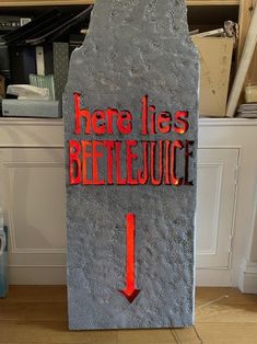 there is a sign that says here lies beetlejuice