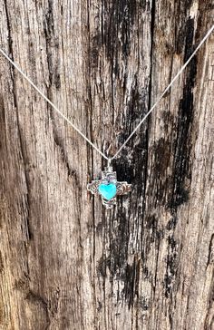 These Beautifully Engraved Heart Zia necklaces are perfectly dainty enough to wear daily! We have four options of colors Blue Turquoise, Agave Green, Cultured Opal and Jet Black Blue Cross Pendant Necklace For Gift, Handmade Turquoise Cross Pendant Necklace, Spiritual Blue Cross Pendant Necklace, Blue Cross Necklace As Gift, Dainty Blue Heart-shaped Necklace, Spiritual Blue Jewelry With Heart Charm, Bohemian Blue Cross Jewelry, Heart-shaped Turquoise Necklace As Gift, Blue Dainty Necklace With Heart Charm