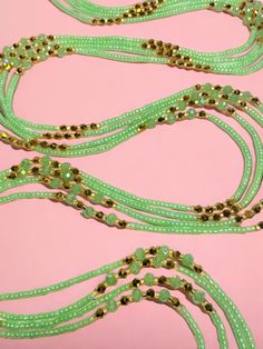 Single Strand Waist Bead, featuring delicate seafoam green glass seed beads accented with luxurious gold crystal glass beads. Why You'll Love It: Subtle Elegance: Seafoam green glass seed beads offer a soft, soothing sparkle that complements any outfit. Luxurious Accents: Gold crystal glass beads add a touch of sophistication and opulence. Perfect Fit: The adjustable single strand design ensures comfort and a secure fit for all body types. Cultural Beauty: This piece blends the rich heritage of Handmade Green Waist Beads, Bohemian Green Beaded Bracelets With Gold Beads, Adjustable Green Beaded Bracelets With Gold Beads, Green Beaded Bracelet With Gold Beads, Green Beaded Necklace With Gold Beads As Gift, Gold Beaded Chain For Summer, Gold Beaded Bracelets For Summer Parties, Elegant Green Beaded Necklace With Tiny Beads, Gold Spacer Beads Jewelry For Summer