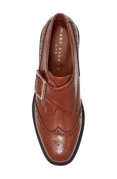 Brogue perforations and wingtip styling add timeless elements to a lofty platform loafer fashioned with an adjustable monk strap for a secure fit. 1 1/2" heel; 1" platform Adjustable monk strap with buckle closure Leather upper/synthetic lining and sole Imported Fall Monk Strap Shoes With Brogue Detailing And Wingtip, Fall Office Wingtip Platform Loafers, Brown Wingtip Platform Loafers With Brogue Detailing, Fall Business Wingtip Platform Loafers, Fall Wingtip Platform Loafers For Work, Fall Wingtip Loafers With Brogue Detailing, Leather Wingtip Platform Loafers With Brogue Detailing, Formal Wingtip Platform Loafers With Brogue Detailing, Fall Monk Strap Shoes With Brogue Detailing