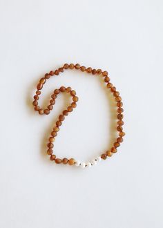 Luxury Amber Oval Beaded Necklace, Cheap Amber Beaded Jewelry, Luxury Amber Spiritual Necklace, Minimalist Jewelry In Natural Tones As A Gift, Nature-inspired White Necklace With Natural Stones, Minimalist Brown Necklaces For Gifts, Minimalist Brown Necklace For Gifts, Minimalist Brown Necklace For Gift, Round Natural Color Necklace As Gift