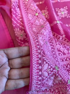 A very very pretty Chikankari saree in pure georgette in a lovely candy pink shade with all over jaal (barfi pattern) embroidery with mukaish work (embellishments). The pallu is short but features intricate designs. The entire saree has the same pattern from the very beginning of the saree except the portion you have to tuck in so that it doesn't bulge. Entire saree is framed in cord piping, best quality satin falls are attached and picot stitching is done as well. The blouse piece is separated Pink Chanderi Dupatta With Chikankari Embroidery, Pink Chikankari Embroidery Salwar Kameez In Georgette, Festive Pink Salwar Kameez With Chikankari Embroidery, Pink Chikankari Embroidery Salwar Kameez For Festive Occasions, Pink Dupatta With Intricate Embroidery For Navratri, Pink Embroidered Dupatta For Navratri, Pink Salwar Kameez With Intricate Embroidery For Festivals, Pink Chikankari Embroidered Dupatta For Festivals, Pink Embroidered Salwar Kameez For Festivals