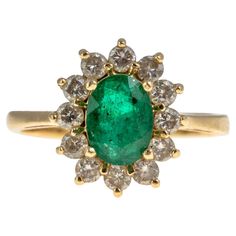 14KG Emerald And Diamond Cocktail Ring Beautiful vintage 14k yellow gold Princess Di style cocktail deep green emerald and diamond ring. Mounting with an oval faceted green emerald center of approximately 1.25 carats. Surrounded by a halo of round 12 brilliant cut diamonds with a combined weight of approximately 0.7 carats. Marked 14k. Size 8. Total weight approximately 4.1 grams. Luxury Vintage Emerald Ring With 17 Jewels, Emerald Cocktail Rings Diamonds, Luxury Vintage Cluster Emerald Ring, Luxury Vintage Hallmarked Emerald Ring, Emerald Cocktail Ring, Sapphire Cocktail Ring, Emerald And Diamond Ring, Vintage Cocktail Ring, Diamond Cocktail Ring