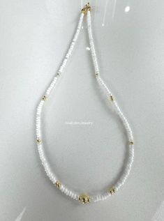 White Dainty Necklace With Spacer Beads, Dainty Beaded Necklaces With Gold Beads, Dainty White Necklace With Spacer Beads, Dainty Gold Beaded Necklaces, Gold Beaded Necklaces With Faceted Beads For Everyday, Gold Beaded Necklace With Faceted Beads For Everyday, Everyday White Beaded Jewelry, White Pearl Beaded Necklaces In Rondelle Shape, White Dainty Jewelry With Spacer Beads