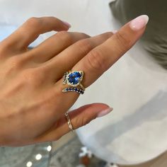 LOGAN HOLLOWELL ONLINE & IN-STORE EXCLUSIVE 18k gold and premium water drop blue sapphire in an elegant crown bezel setting with a full pavé white diamond halo totaling 0.25 carat weight. Logan Hollowell, Elegant Crown, Baby Queen, Layered Rings, Hand Chain, Aquamarine Blue, Diamond Halo, Water Drop, Bezel Setting