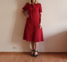 "Vintage Dress Red Women Dress Short Sleeve Dress Red Button up Secretary Dress A-Line Polyester Dress Lined Shoulder Pads Shown on model M/L Measurements: (lying flat) Shoulder: 15\"/ 38 cm Sleeve: 9.5\"/ 24 cm Bust: 18.5\"/ 47 cm Waist: 16.5\"/ 42 cm Length: 44\"/ 112 cm Please check measurements to insure a proper fit. Remember to allow yourself some extra room for movement. You can compare these with something from your closet that fits you well Condition: great Vintage Condition N.B. Color may slightly differ from picture. SHIPPING * I ship worldwide via Priority mail * Items are shipped 3 - 5 business days after receiving the payment. * I ship from Europe, so please allow 2 to 3 weeks for the package to arrive if you live overseas. * Europe 5 - 10 business days. BK 2" Red A-line Midi Dress With Buttons, Red Fitted Vintage Midi Dress, Red Fitted Midi Vintage Dress, Retro Knee-length Midi Dress With Buttons, Red Short Sleeve Shirt Dress For Work, Red Buttoned Shirt Dress For Summer, Red Shirt Dress With Buttons For Spring, Fitted Red Shirt Dress, Red Midi Dress With Button Closure