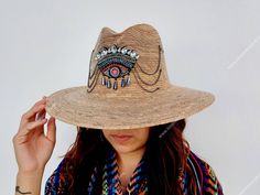 I love Mexico celebrates the native crafts of Mexico and the artists that produce them, enabling them and their communities to get recognized for their talented work and achieve economic stability for their families. This listing is for one piece of this beautiful handmade straw hats. They are prefect to add to your closet for your favorite dress, providing shade from the warm summer sun. The eye decoration is hand embroidered. Consist of decorative gems. You will get the exact same piece shown Handmade Straw Hat For Spring Rodeo, Handmade Straw Hat For Rodeo In Spring, Handmade Bohemian Straw Hat For Spring, Bohemian Handmade Straw Hat For Country Events, Handmade Straw Hats For Rodeo, Handmade Bohemian Straw Hat For Country Events, Bohemian Handmade Sun Hat For Rodeo, Handmade Western Straw Hat For Festival, Handmade Panama Hat For Festivals