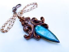 Hi Everyone, I've just finished this Neo-Baroque Pendant featuring a Floral Motif and Gem Quality Faceted Labradorite. Pendant is suspended on delicate Lozenge Link Chain accented with Fish Hook Clasp.  Pendant Height is 3 inches Chain Length is 20 inches  $127.oo + shipping Elegant Patina Pendant Necklace, Elegant Pendant Necklace With Patina, Elegant Patina Necklaces As Gift, Elegant Patina Necklaces For Gifts, Neo Baroque, Live Oak, Labradorite Necklace, Crystal Necklaces, Labradorite Necklaces