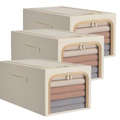 three storage bins with handles and zippers on each side, one for folded clothes