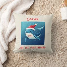 a christmas pillow with an image of a dolphin wearing a santa's hat on it