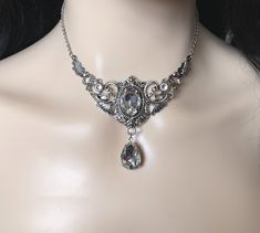 "Choker: This elegantly ornate necklace is made with antique silver tone centerpieces, featuring lavish baroque details. Its mesmerizing design is accented with dazzling crystal clear glass crystals/jewels. Decorated portion is 4\" wide and 2 1/2\" tall in the very center. Necklace length is adjustable 14\"-17\" with soldered stainless steel cable chain, lobster clasp and extender. If you would like a different length, please send us a message. Earrings: These dainty and elegantly ornate earring Ornate Silver Jeweled Necklaces, Ornate Silver Jeweled Necklace, Ornate Silver Bridal Necklace, Silver Crystal Necklace With Intricate Design, Silver Necklace With Intricate Crystal Design, Antique Silver Jeweled Necklace, Gothic Wedding Necklaces With Jewels, Silver Bridal Necklace With Intricate Crystal Design, Gothic Silver Crystal Jewelry