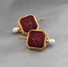 Description Gemstone - Red Glass Material - Brass Gemstone Size - 18 mm Earring Height Including Hoop - 4 cm Earring Width - 2.3 cm Finish - Smooth and high polished with brilliant shine. Note -The earrings are made to order, production day is about 3-5 working days. The one you receive may be slight different from the one in the picture due to handmade nature, but it will be almost same as in the above picture.These pieces are handcrafted from start to finish and have an imperfect handmade look.These earrings are the perfect addition to your collection. Our rings are meant to be classic enough for everyday wear or to give as a bridesmaid gift. You will receive the same piece as in the picture or identical. Since all gemstones are different from each other, I cannot guarantee that the gems Red Cabochon Earrings For Wedding, Red Pendant Earrings For Anniversary, Red Gemstone Pendant Earrings, Red Cabochon Earrings Perfect For Gifts, Red Cabochon Earrings For Gift, Vintage Red Gemstone Earrings, Jewlery Rings, Silver Jewlery, Printed Dress Shirts