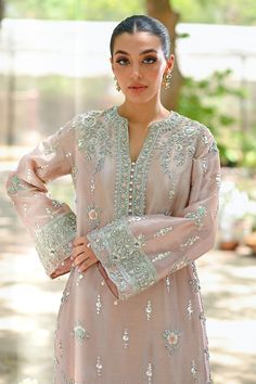 "A contemporary take on a classic kaftan silhouette, cut from tissue, in an elegant shade of blush pink. Dispersed kamdani and zardoze details with a cutworked hem elevate the look." Pink Wedding Kaftan For Eid, Pink Resham Embroidery Kaftan For Wedding, Pink Zari Work Kaftan For Weddings, Pink Wedding Kaftan With Zari Work, Elegant Pink Kaftan With Resham Embroidery, Pink Kaftan With Dabka Work For Wedding, Elegant Pink Festive Kaftan, Pink Wedding Kaftan With Dabka Work, Festive Pink Elegant Kaftan