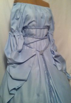 New fantasy Renaissance style of a beautiful Baby Blue gown with a noble puff sleeve and dagget Druid era  longer sleeve. The dress will fit a variety of sizes as belt ties around to fit any size body '  the dress has a Wrap around belt and a brooch to match the dress, Want to change color of belt, Let me know.  Please send me your height, dress size and the inches around your upper arm in order to ensure that your chemise fits as it should when you order the dress. I always get the dresses made Blue Long Sleeve Victorian Wedding Dress, Blue Long Sleeve Victorian Dress For Wedding, Elegant Blue Victorian Dress For Fancy Dress, Blue Victorian Dress With Ruffles For Fancy Dress, Elegant Fitted Blue Victorian Dress, Blue Historical Costume Party Dress, Blue Historical Dress For Costume Party, Blue Historical Design Dress For Costume Party, Fitted Blue Victorian Dress For Wedding