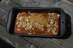 a loaf of bread topped with almonds in a pan