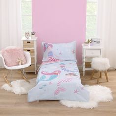 The Everything Kids Mermaid 4 Piece Toddler Bed Set includes a comforter, fitted bottom sheet, flat top sheet, and reversible pillowcase. This whimsical comforter measures 42" x 57" and features lovely mermaids with starfish, seashells, and fishy friends, designed in shades of light blue, pink, rose and aqua; reverses to rose pink. The pink top sheet measures 45" x 60" and the pink fitted bottom sheet measures 28" x 52” and includes full elastic edges for a safe and snug fit. This set fits a sta Toddler Mermaid Bedding, Bedroom Toddler Girl, Girls Mermaid Bedroom, Mermaid Bed, Reversible Pillowcase, Blue And Pink Bedroom, Toddler Bed Girl, Mermaid Bedding, Toddler Comforter