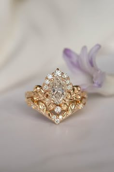 a close up of a ring on a white surface with flowers in the foreground