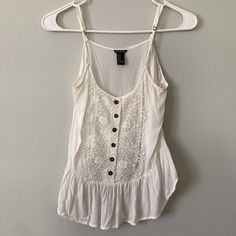 Like New! Beautiful Lace Detailing And Cute Buttons Dress Up This White Spaghetti Strap Tank Top From Forever 21. The Back Is Cropped, Whereas The Front Is Not, Giving This Top A Low-High Silhouette Forever 21 Summer Cami Tank Top, Forever 21 Cami Tank Top For Summer, White Trendy Camisole For The Beach, Trendy White Camisole For The Beach, Trendy White Camisole For Beach, Forever 21 Summer Camisole Tank Top, Forever 21 Camisole Tank Top For Summer, Forever 21 Cami Tops For Summer, Forever 21 Summer Cami Top