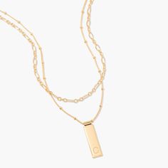 Be fabulous in this 14k gold plated layering necklace set that combines personalized beauty and modern glamour. The rectangle pendant is personalized with your initial and hangs from a satellite chain which is paired with a delicate chain to create an iconic look. Be fabulous day or night with this stunning necklace set. Available in 14k gold plated brass Maisie Pendant: Size: 1" by 1/4"; Length: 18" satellite chain with 2" extender Vivi Necklace: Size: 4mm; Length: 16" chain with 2" extender Lo Elegant Personalized Necklace With Rectangular Links, Elegant Layered Necklace With Initial Pendant, Elegant Layered Initial Pendant Necklace For Gift, Elegant Gold Initial Necklace For Layering, Elegant Layered Necklace With Initial Pendant For Gift, Elegant Everyday Rectangular Initial Necklace, Elegant Gold Rectangular Initial Necklace, Elegant Yellow Gold Rectangular Initial Necklace, Elegant Personalized Charm Necklaces