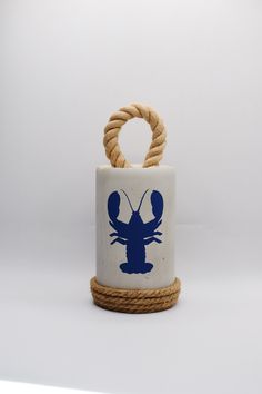 a blue and white lobster on a rope holder