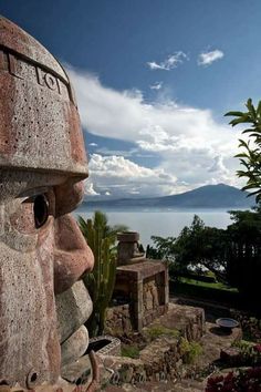 a large statue is in front of a body of water