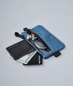 Stow your cards and cash quickly in our smallest pouch. Designed for those who want to carry as little weight as possible, the Zip Pouch has secure storage space for frequently used items such as credit cards and bank notes. With an extra pouch for coins or smaller items like your spare SIM card, you'll find room even for business cards too! Functional Daily Bag With Card Slots, Practical Travel Accessories With Pockets For Everyday Use, Functional Rectangular Travel Accessories With Pockets, Rectangular Functional Travel Accessories With Pockets, Multifunctional Travel Accessories With Pockets For Everyday Use, Practical Rectangular Travel Accessories With Pockets, Multifunctional Travel Accessories For Daily Use, Blue Zipper Pouch Case For Storage, Blue Zipper Pouch Case