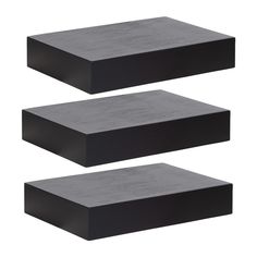 three pieces of black concrete sitting next to each other on a white background with no one in the photo