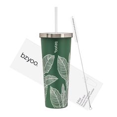 a green travel cup with a straw in front of it and a tag on the side