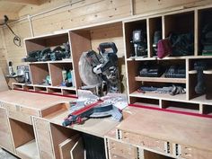 the workbench is full of many different tools and equipment, including a circular saw