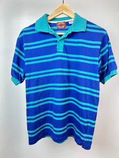 "Vintage 90's 80's Green and Blue Striped Short Sleeve Polo | Retro horizontal strip polo | River Trader Polo | Small Unisex Condition: Good Vintage Condition  Tag says: Medium Looks like: Small Tagged Vintage sizes vary and are mostly different from modern sizes.  Please see measurements below and feel free to reach out with questions.  Measurements  Pit to pit: 19.5 inches Top of shoulder/collar to bottom of shirt: 24 inches  All items are vintage and previously owned/worn. We try to include all \"imperfections\" in the photos.  Thanks for your support!" Blue Polo Shirt With Striped Collar, Summer Striped Collared Polo Shirt, Striped Collared Polo Shirt For Summer, Blue Striped Polo Shirt For Summer, Summer Striped Polo Shirt, Summer Casual Polo Shirt With Contrast Stripes, Casual Summer Polo Shirt With Contrast Stripes, Casual Summer Polo Shirt With Striped Collar, Retro Striped Polo Shirt With Polo Collar