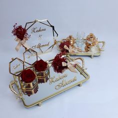 two mirrored trays with red roses on them