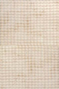 an old textured wallpaper with white and beige colors