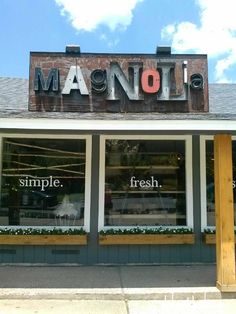 a store front with the words manolo written on it's windows and outside