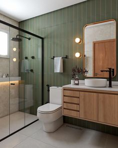 a bathroom with a toilet, sink and shower stall in the middle of it's tiled walls