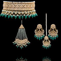 This regal set befitting a queen's closet, pays tribute to Mughal royalty and is the classiest way to embrace the festive season! A charmingly curated set, intricately detailed with the rich emerald drops and garnished with lush CZ and faux pearl beads. Approximate earrings length is. This set is available in 3 options: Necklace + Earrings Necklace + Earrings + Teekah Necklace + Earrings + Teekah + Jhoomar Please select the desired option at the time of purchase. Gold-plated on high-quality brass as the base metal. Made by order. Kindly allow 7-8 weeks for the delivery of this item. For custom or urgent requests, please contact support@alacouture.com. *Please Note: We use faux stones and beads in all of our jewelry. Elegant Kundan Necklace With Zari Work For Ceremonial Occasion, Elegant Jhumkas With Zari Work For Festivals, Elegant Chandbali Tikka With Zari Work, Elegant Zari Work Necklace For Eid, Elegant Stone Work Anarkali Set For Festive Occasions, Elegant Bridal Sets With Zari Work For Ceremonial Occasion, Elegant Bridal Sets With Zari Work For Ceremonial, Elegant Ceremonial Bridal Sets With Tilla, Elegant Anarkali Set With Stone Work For Eid