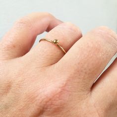 A super cute, tiny ball ring looks great alone or stacked up! All 14K Gold Filled Made from 1mm full round wire. Ball is 3mm Comes in sizes 5-9 Gold Filled has 100 times more gold than gold plated jewelry. Gold filled wire is created by taking a sheet of 14 karat gold and bonding it through extreme heat and pressure to a core of semi-precious metal (brass). This is a very sophisticated process and only a few mills in the world do it. You should not mistake this process for gold plating as there Simple Tiny Stackable Round Rings, Tiny Simple Round Stackable Rings, Simple Tiny Round Stackable Rings, Simple Tiny Stackable Rings With Round Band, Simple Tiny Stackable Rings, Simple Gold Jewelry, Delicate Stacking Rings, Delicate Gold Ring, Dainty Gold Rings