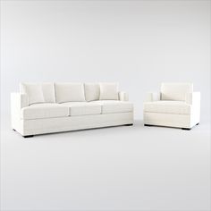 two white couches sitting next to each other on top of a white flooring