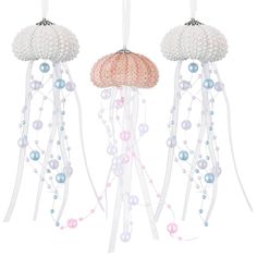 three white and pink jellyfish decorations hanging from strings