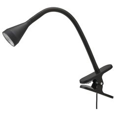 a black desk lamp on a white background with clippings to the left side