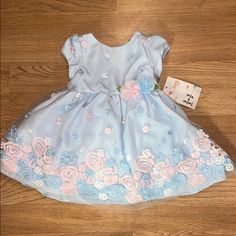 Light Blue Flower Dress. Size 12. Cuter Easter Dress! Brand New Blue Floral Applique Dress For Dress-up, Spring Floral Pink Dress For Casual, Spring Pink Floral Dress, Cute Blue Dresses With Floral Applique, Cute Blue Dress With Floral Applique, Cute Blue Floral Dress For Spring, Blue Floral Print Playtime Dress, Blue Dresses With Floral Applique For Dress-up, Spring Princess Playtime Dresses