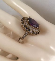 Stunning Vintage Dress Ring  With beautiful Amethysts and Sapphires  Ring size R. The inside diameter of the ring band is 1.88 cm (This is a medium ring size) The Classic Victorian setting is 2 cm long,  1.8 cm wide and sits 1 cm high  The large central stone is 1.1 cm long and 9 mm wide  and is securely claw set  All of the accent stones set all around  are all securely set and all are present, none are missing Stamped 925. Weighs 5.86 grams   A stunning Statement ring, in very good vintage con Gold Amethyst Ring For Wedding, Fine Jewelry, Elegant Multi-stone Amethyst Wedding Ring, Gold Amethyst Ring With Center Stone For Wedding, Elegant Wedding Amethyst Gemstone Ring, Elegant Amethyst Wedding Ring, Elegant Wedding Amethyst Ring, Elegant Multi-stone Diamond Wedding Ring, Elegant Gold Amethyst Ring With Halo Setting, Elegant Amethyst Rings For Wedding