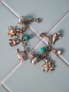 SEA CHARMS BRACELET, by Sarah Coventry, Circa 1964, Seashells, Clams with Pearls Sea Charms, Linked Bracelet, Mid Century Jewelry, Green Pearls, Charms Bracelet, Sarah Coventry, Coventry, Sea Green, Bracelets And Charms