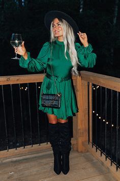 Green Christmas Party Dress, Christmas Dress With Boots, Green Silk Dress Long Sleeve, Green Dress For Christmas, Green Satin Dress Outfit, Long Sleeve Dress With Boots, Emerald Green Dress Outfit, Christmas Cocktail Dress, Dark Green Sweater Dress