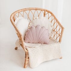 a wicker chair with a pillow on top of it