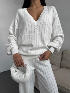 "White knitted pantsuit with a knitted pattern is stylish and cozy!  The set is knitted from a natural blend of cotton and viscose yarn and consists of a deep V neck sweater and straight fit pants, pleasant to the body and to the touch.  The suit can be worn anywhere as a casual outfit for every day, walking, traveling or a cozy home look.   DETAILS  - white  - 80% cotton, 20% viscose  - knitted pattern  - loose fit  - deep V neck - straight fit pants   SIZES   This suit is available in 3 sizes XS-S,  M-L and XL-XXL  Dropped sleeve 31.5\"/ 80 cm  Back length 25.6\"/ 65 cm  Pants length 42.9\"/ 109 cm  Inseam 30.7\"/ 78 cm Size  XS - S  bust 84-88cm = 33.08-34.64 inches,  waist 63-67cm = 24.8 - 26.37 inches  hips 92-96 = 36.22-37.80 inches.   M-L BUST 36-37.7 inches / 92-96 cm WAIST 28-29.5 White Knitted Long Sleeve Set, Cable Knit Sweater For Loungewear, Pointelle Knit Sweater For Loungewear In Fall, Fall Pointelle Knit Sweater For Loungewear, Casual White Knit Sets, Stretch Knit Sweater For Loungewear, Textured Knit Sweater For Loungewear, White Knit Sweater For Loungewear, White Textured Knit Sweater For Loungewear