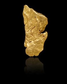 a gold nugget on a black background